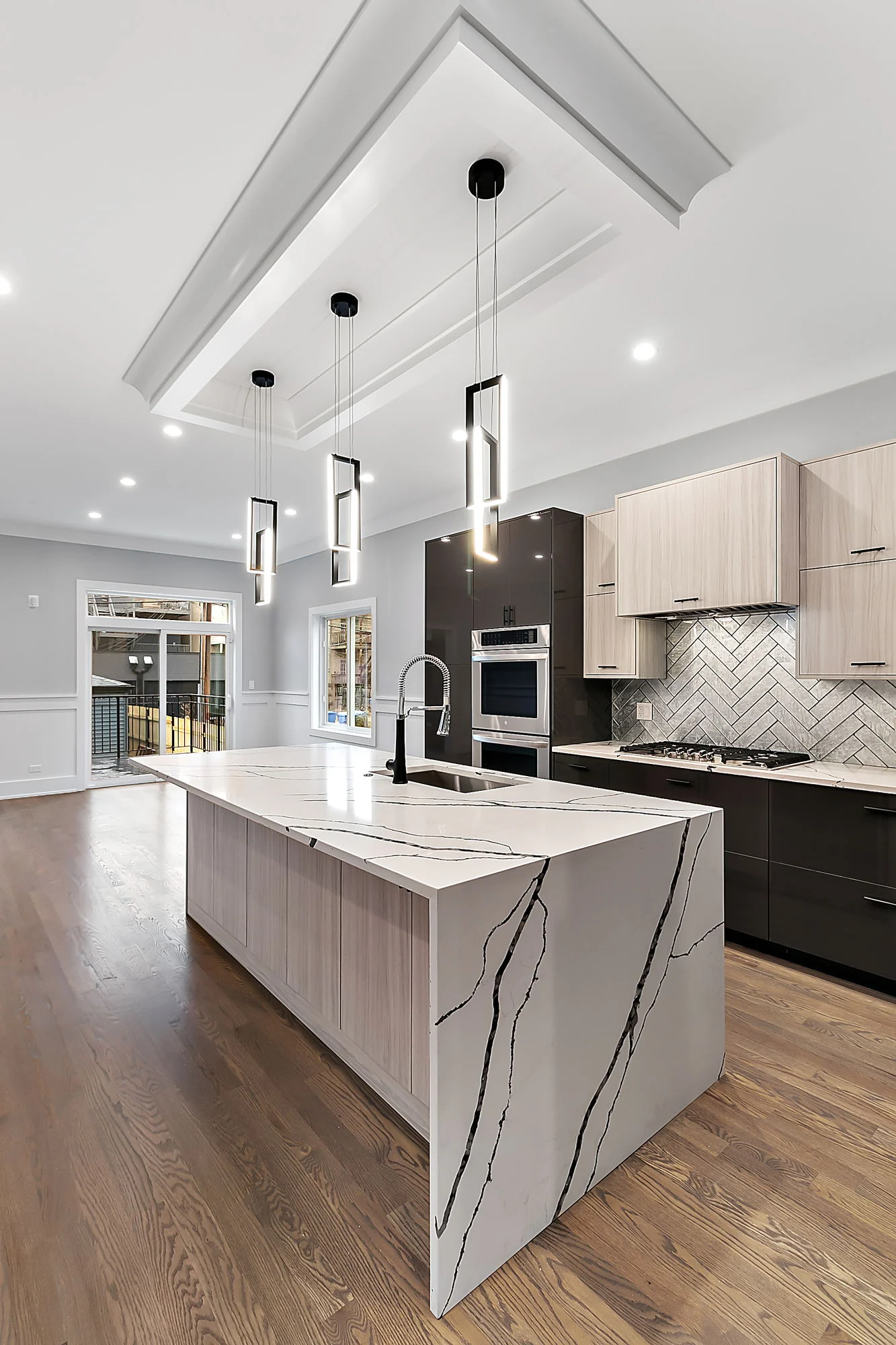 Kitchen with a waterfall island and vaulted ceiling