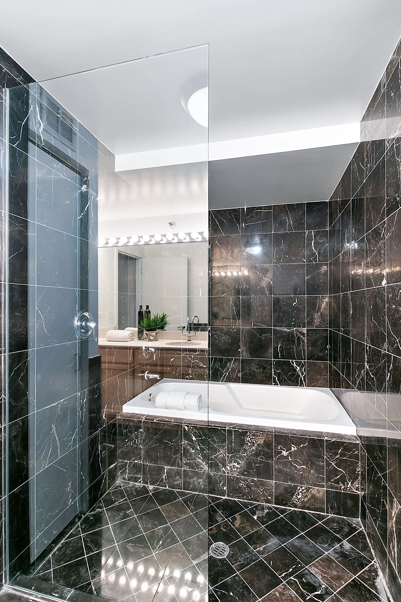 Bathroom with contrasting tile and a bathtub